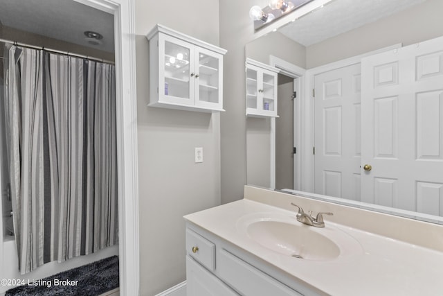 bathroom featuring vanity and a shower with shower curtain