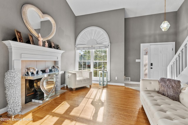 living room featuring a high ceiling and light wood-type flooring