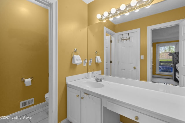 bathroom with vanity, tile patterned floors, and toilet