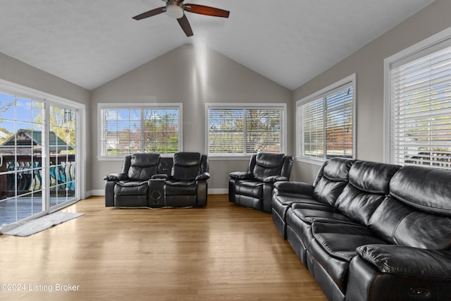 living room featuring ceiling fan, lofted ceiling, and light hardwood / wood-style floors