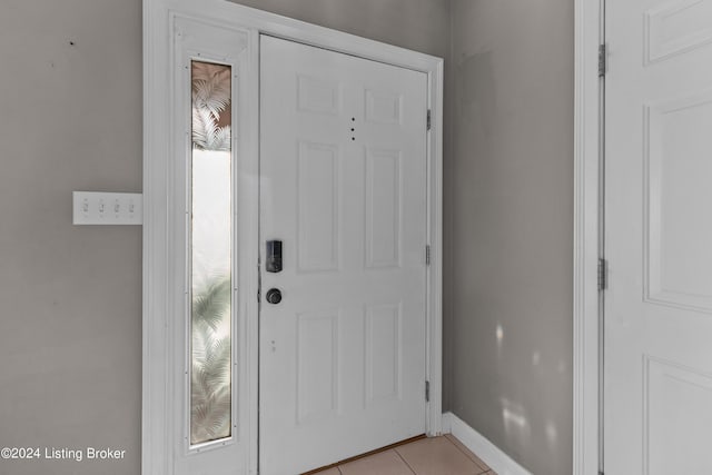 foyer entrance with light tile patterned flooring