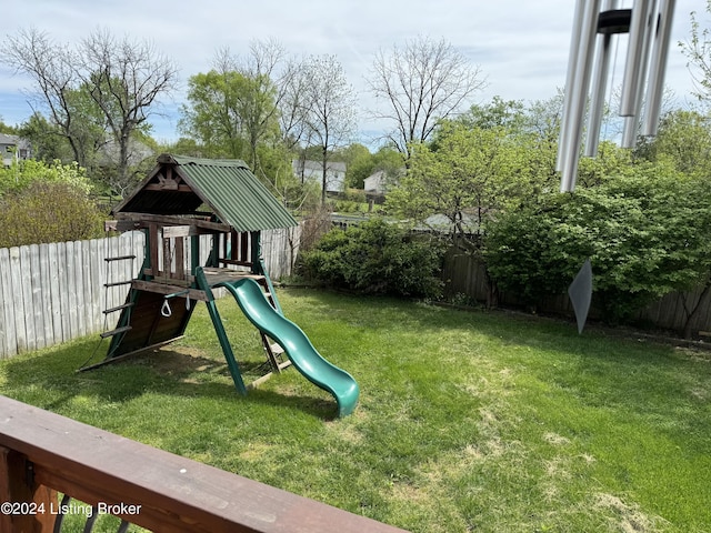 view of jungle gym featuring a lawn