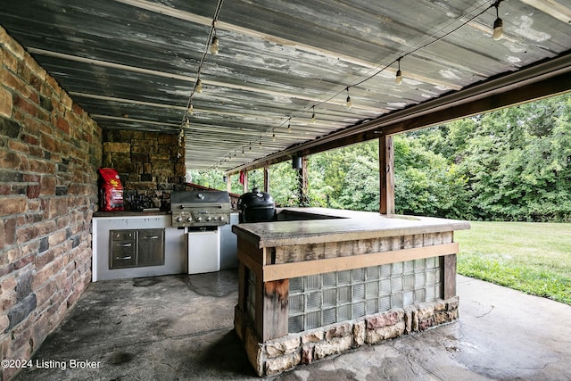 view of patio / terrace featuring a grill and an outdoor kitchen