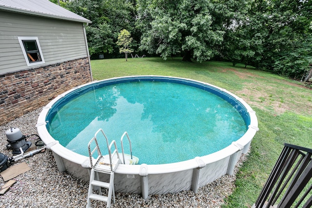 view of pool featuring a lawn