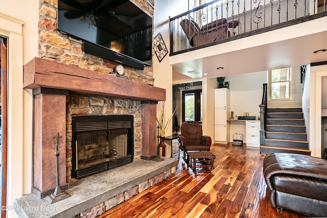 living room featuring hardwood / wood-style floors, a fireplace, and ceiling fan