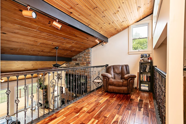 unfurnished room featuring hardwood / wood-style flooring, rail lighting, vaulted ceiling with beams, and wooden ceiling