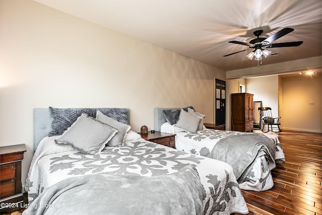 bedroom featuring dark wood-type flooring and ceiling fan