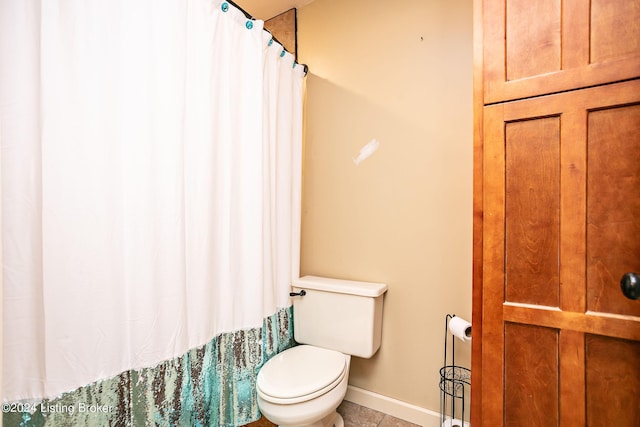 bathroom with tile patterned flooring and toilet