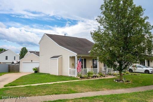 view of front of house featuring a porch, an outbuilding, a garage, and a front yard