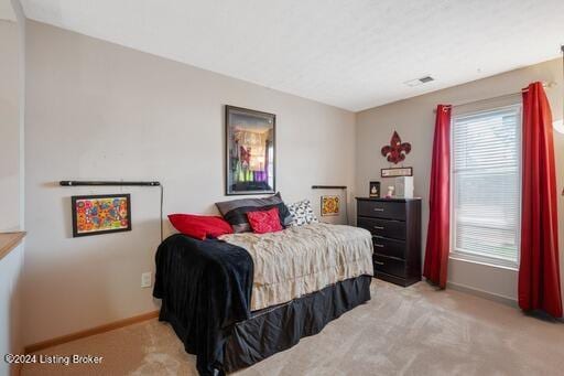 bedroom featuring light colored carpet