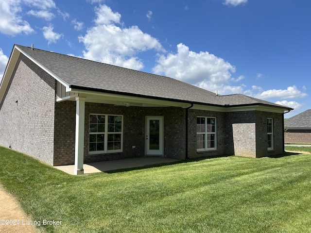 rear view of house featuring a patio area and a lawn