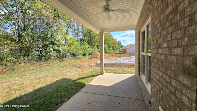 view of yard with ceiling fan and a patio