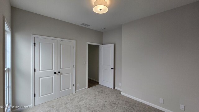 unfurnished bedroom with carpet floors and a closet