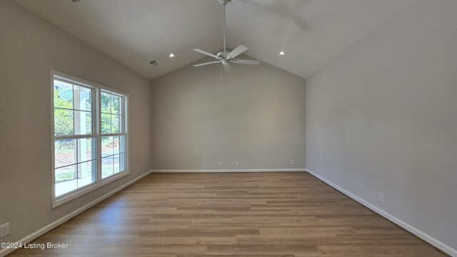 spare room with ceiling fan, lofted ceiling, and light hardwood / wood-style flooring