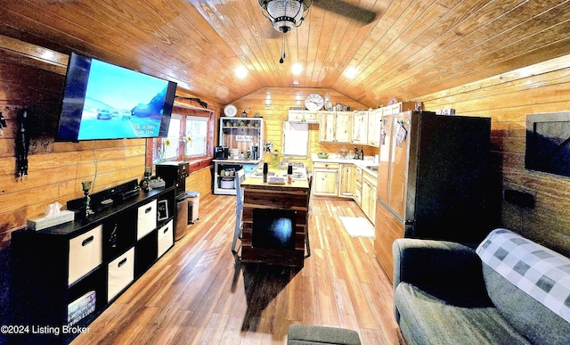 kitchen with light wood-style floors, wood ceiling, vaulted ceiling, and wooden walls