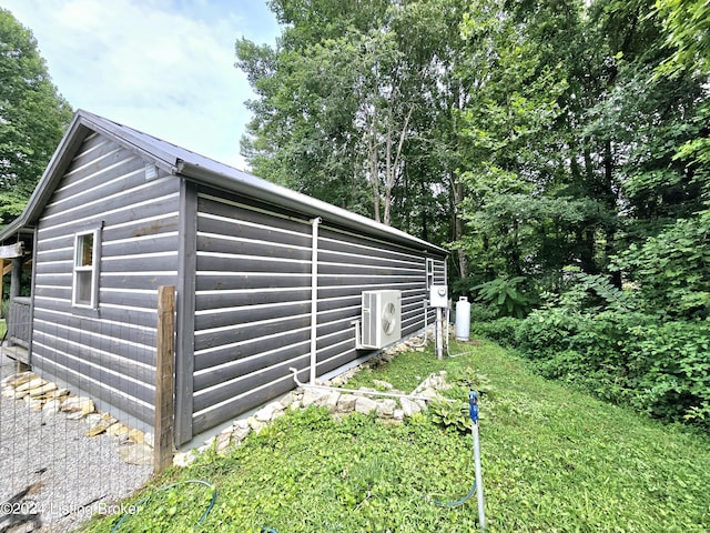view of side of property featuring ac unit and an outdoor structure