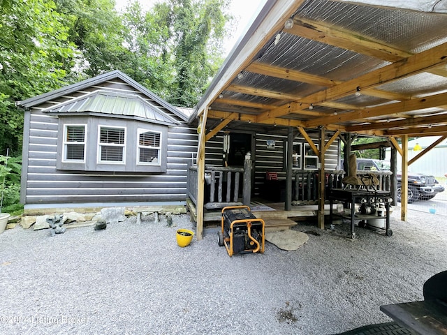 exterior space with faux log siding and metal roof