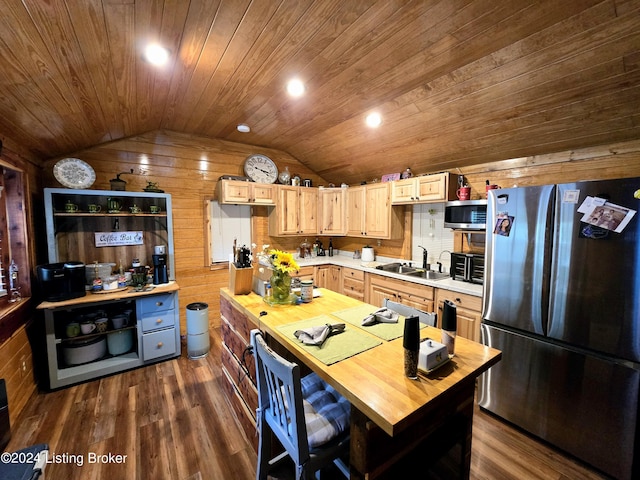 kitchen featuring dark wood-style floors, stainless steel appliances, lofted ceiling, a sink, and butcher block countertops