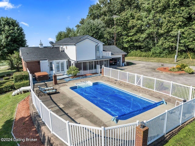 view of pool featuring a hot tub and a patio