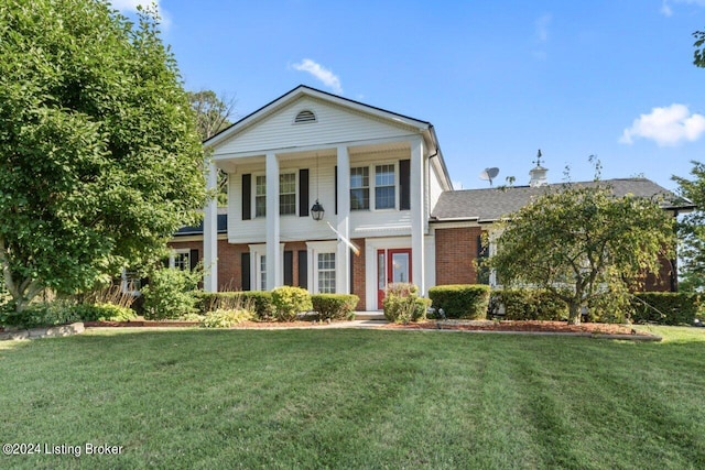 greek revival house with a front lawn