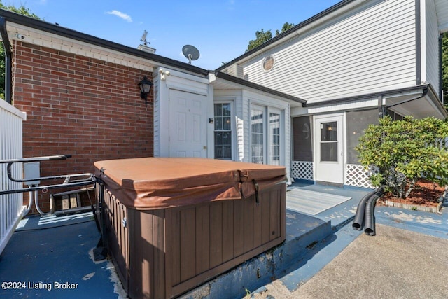 wooden terrace with a hot tub