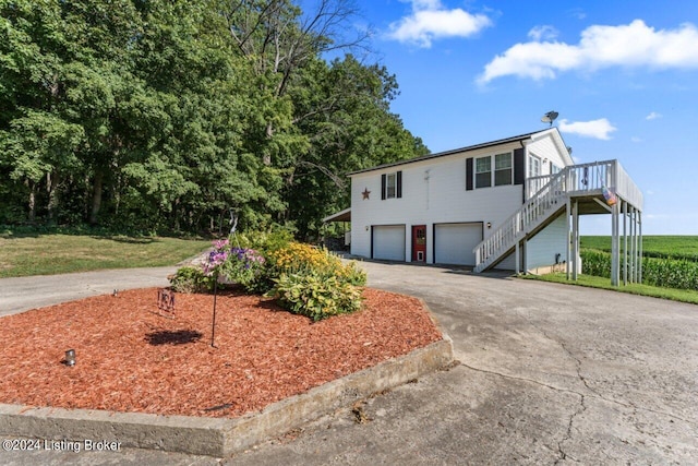 view of front of house with a garage and a deck