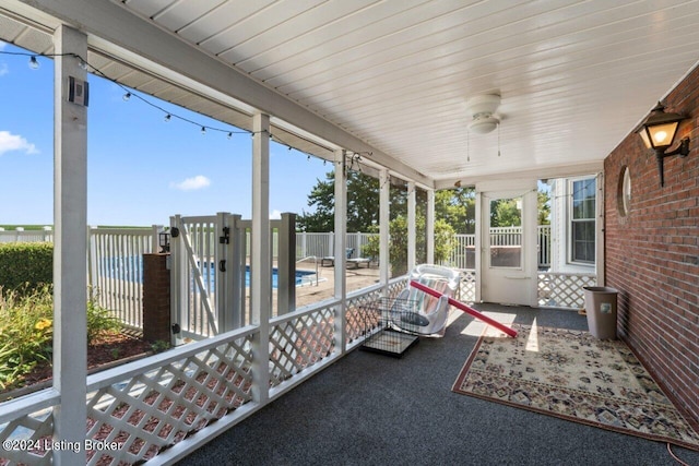 unfurnished sunroom with ceiling fan and a healthy amount of sunlight