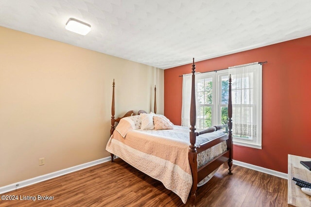 bedroom with wood-type flooring