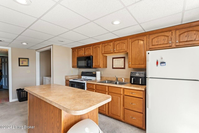 kitchen with a kitchen island, white refrigerator, light carpet, sink, and range with electric cooktop