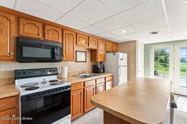 kitchen with sink, electric range, white refrigerator, and a drop ceiling