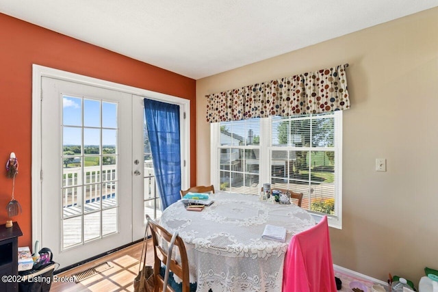 dining space featuring a healthy amount of sunlight and french doors