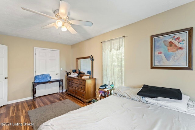 bedroom featuring ceiling fan and dark hardwood / wood-style floors