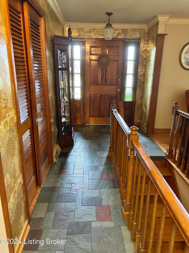 hallway with crown molding and dark tile patterned flooring