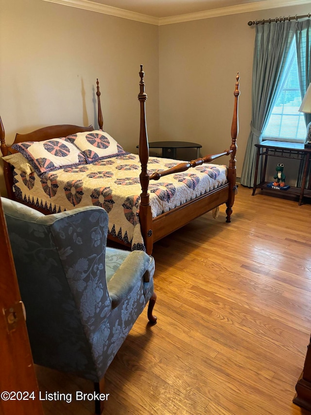 bedroom with crown molding and light hardwood / wood-style flooring