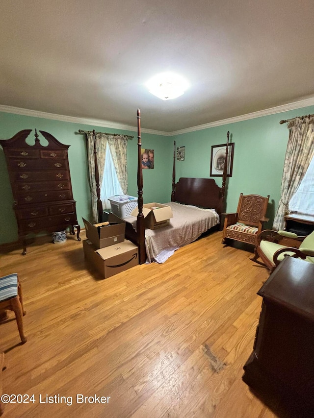 bedroom featuring crown molding and light wood-type flooring