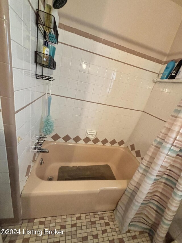 bathroom featuring tile patterned floors and shower / bath combination with curtain