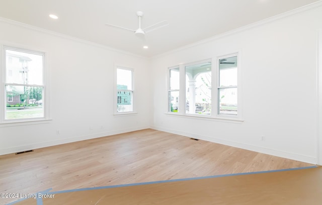 empty room featuring crown molding, ceiling fan, and light hardwood / wood-style floors