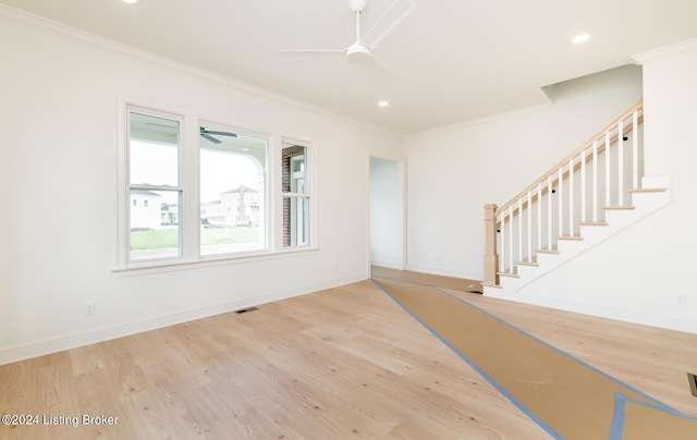 entryway featuring wood-type flooring, ornamental molding, and ceiling fan