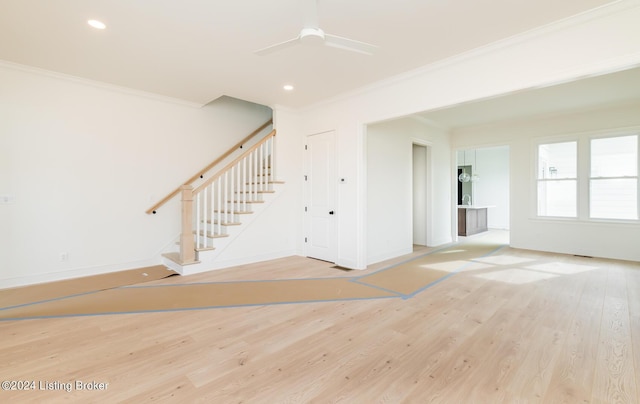 unfurnished room featuring crown molding, ceiling fan, and light hardwood / wood-style floors