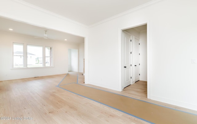 spare room featuring ceiling fan, ornamental molding, and light hardwood / wood-style flooring