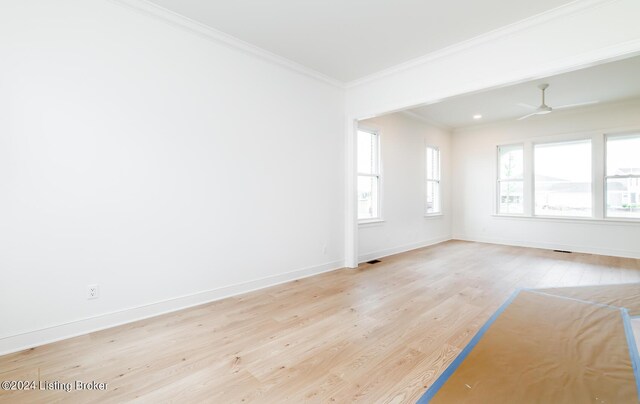 unfurnished room featuring crown molding, ceiling fan, plenty of natural light, and light hardwood / wood-style floors