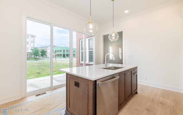 kitchen with sink, hanging light fixtures, ornamental molding, dishwasher, and a kitchen island with sink