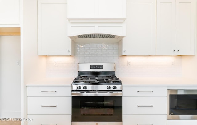 kitchen with white cabinetry, built in microwave, tasteful backsplash, and stainless steel range with gas stovetop