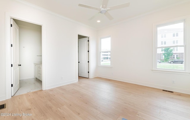 unfurnished bedroom with crown molding, ensuite bath, and light wood-type flooring