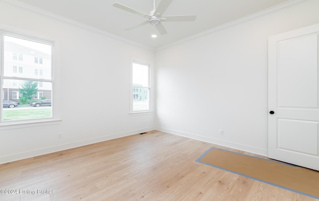 unfurnished room featuring crown molding, a wealth of natural light, ceiling fan, and light hardwood / wood-style flooring