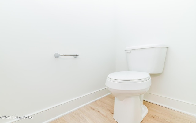 bathroom featuring wood-type flooring and toilet