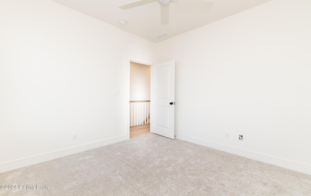 empty room featuring light carpet and ceiling fan