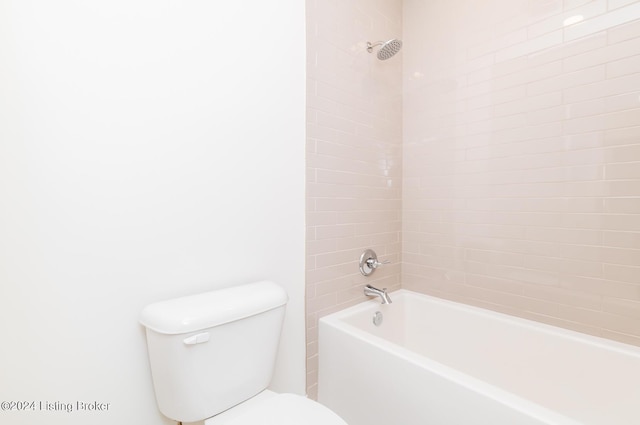 bathroom featuring tiled shower / bath and toilet