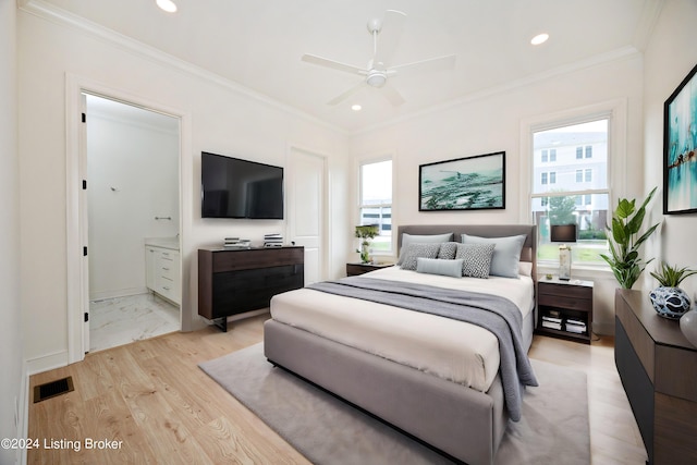 bedroom with crown molding, ensuite bath, light hardwood / wood-style floors, and multiple windows