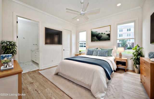 bedroom with crown molding, ensuite bath, and light hardwood / wood-style flooring